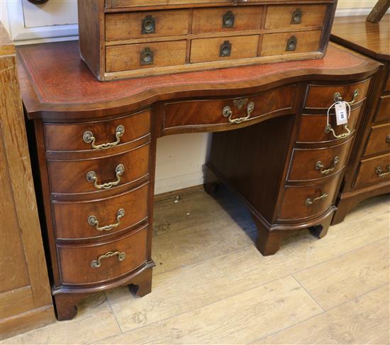 A nine drawer serpentine pedestal desk W.115cm